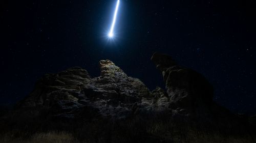 Free Majestic comet and starry night sky above dramatic rock formations in Durango, Mexico. Stock Photo