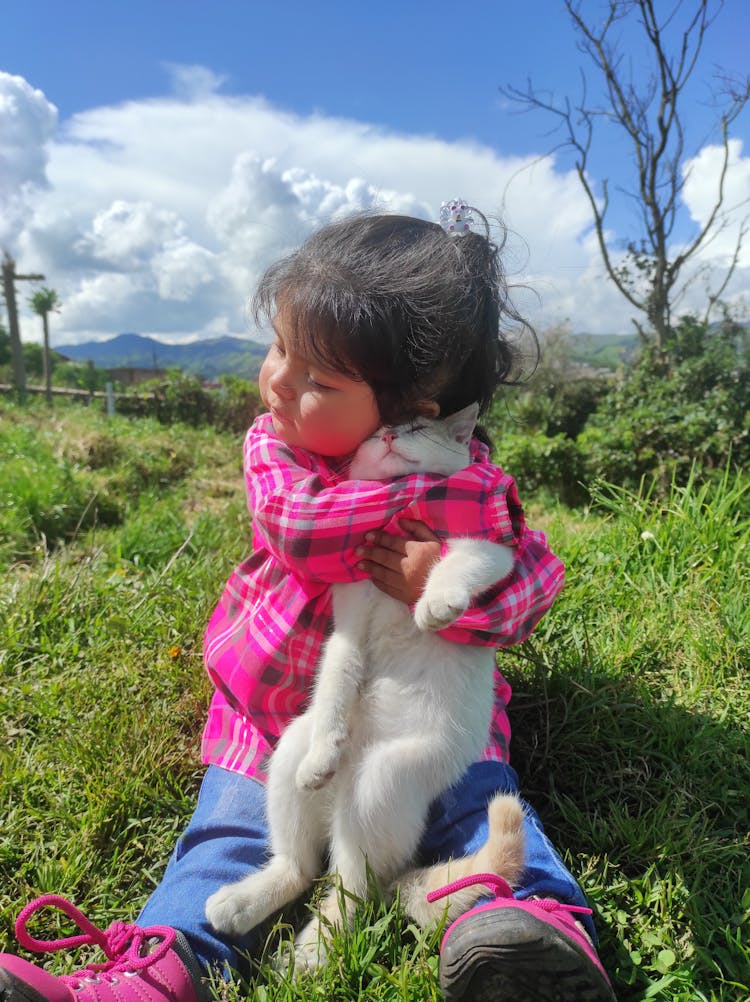 Girl Hugging A Cat