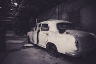 Grayscale Photo of Vintage Car in Garage