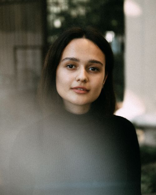 Free Elegant close-up portrait of a young woman with natural lighting and soft focus. Stock Photo