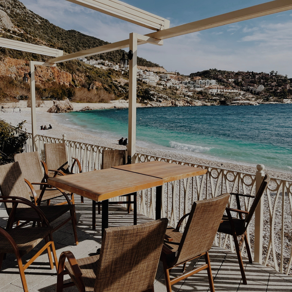 Open-air terrace above a turquoise bay, photo by Alesya Astapovich on Pexels