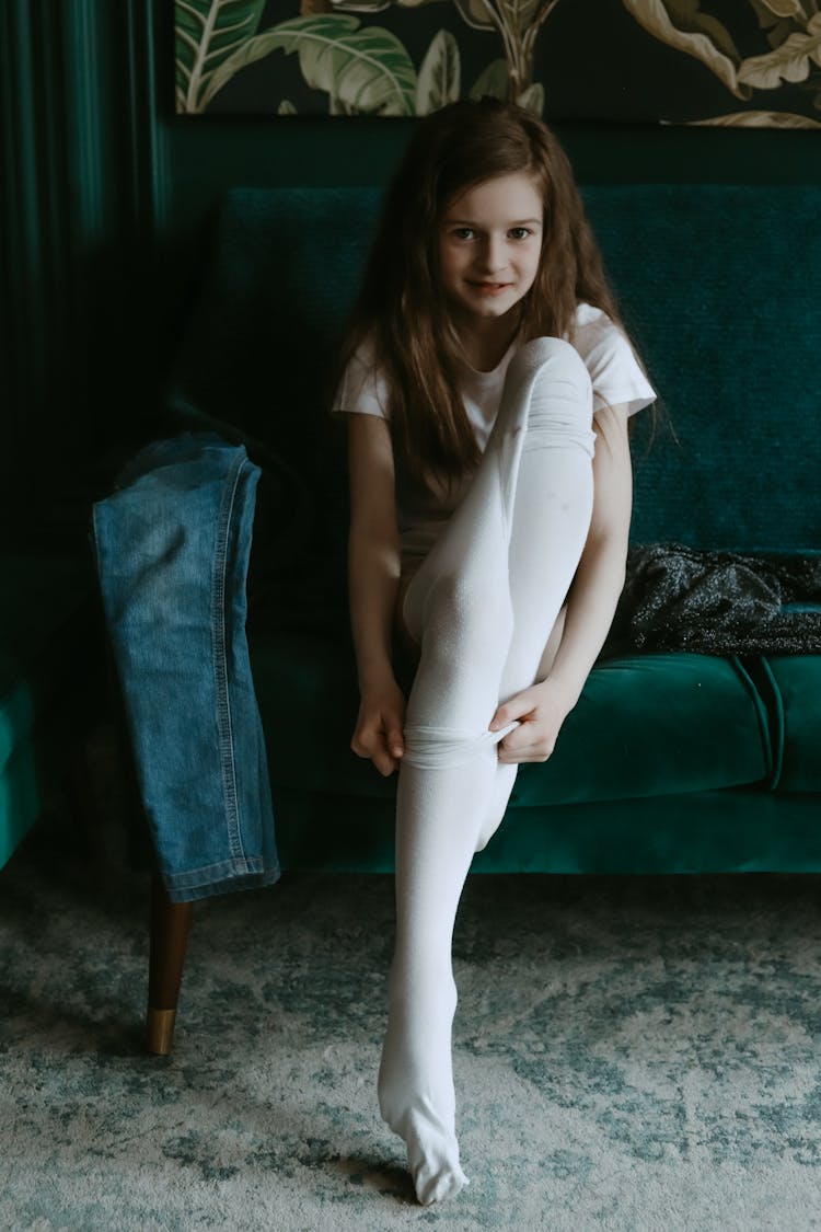 Girl Sitting On Green Couch While Wearing White Tights 