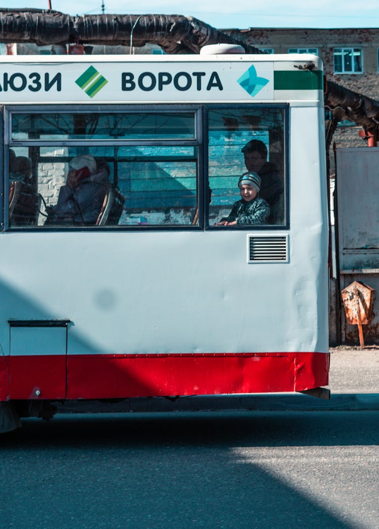 Side View Of A Bus With People