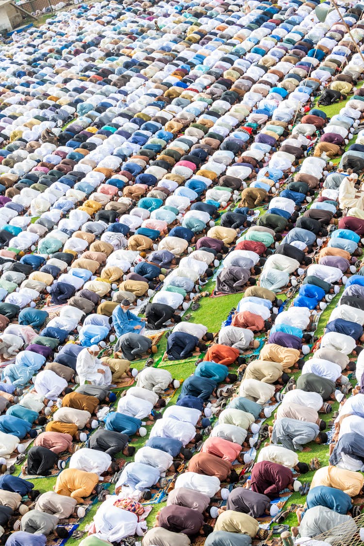 Muslim People Kneeling And Praying