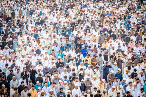 Free Crowd gathers outdoors for mass prayer, showcasing unity and devotion. Stock Photo