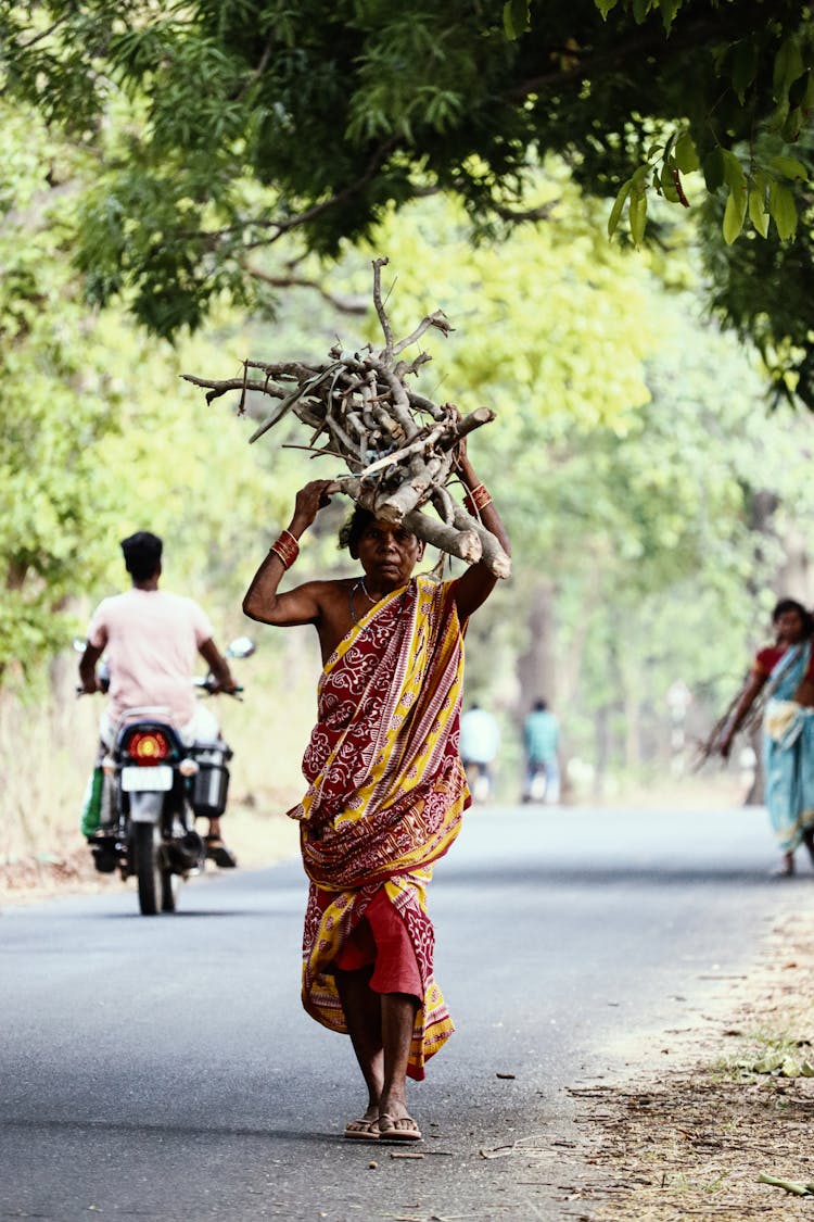 Indian Woman Carrying Firewood On Head