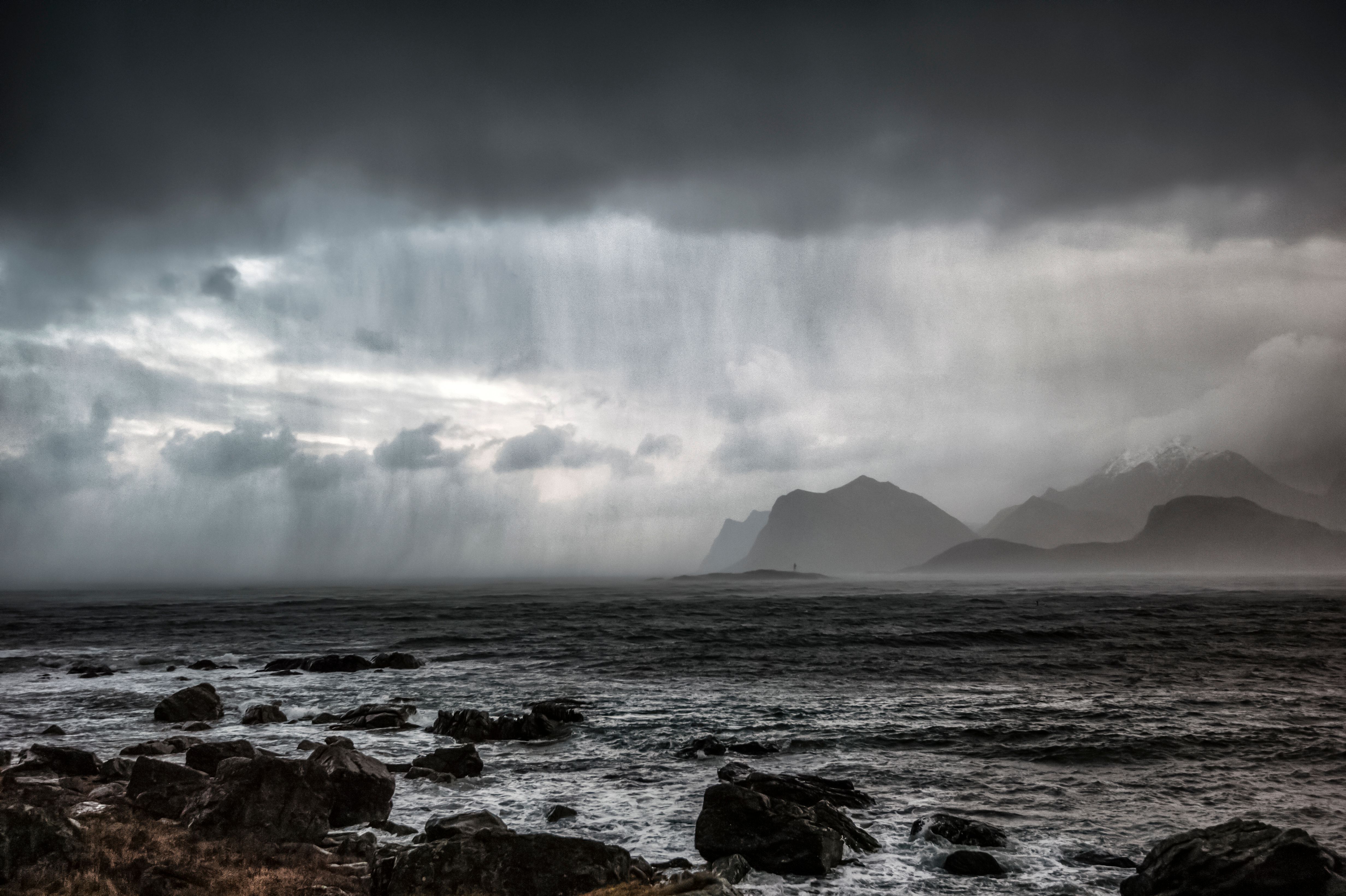 Rocky Shore near Mountains under the Cloudy Sky · Free Stock Photo
