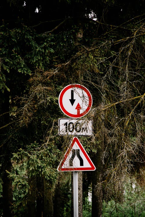 Red and White Road Signs on the Street