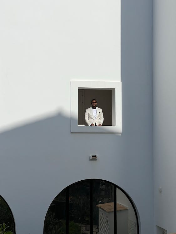 Man in a Tuxedo Loooking Out the Window