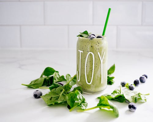 Free Green Fruit and Veg Smoothie Served in Jar with Straw Stock Photo