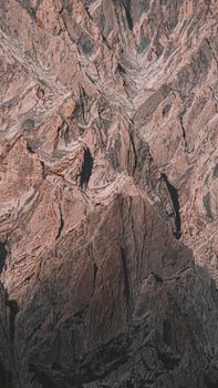 Close-up view of a rugged mountain rock formation with textured detail, perfect for nature and geology themes.