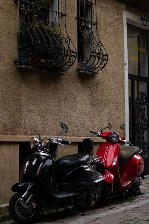 Free Charming urban alley with two scooters parked by a vintage apartment facade. Stock Photo