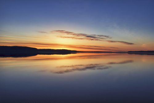 Free A tranquil sunrise reflecting on the calm waters of Lake Pepin in Lake City, Minnesota. Stock Photo