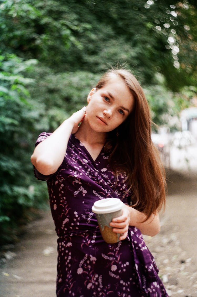 Young Woman Holding A Disposable Coffee Cup 