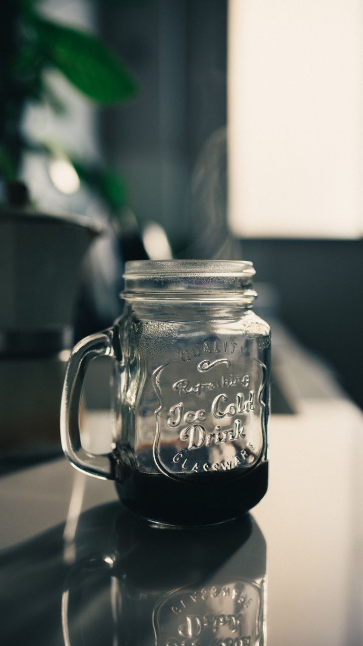 Clear mason jars used for coffee storage on a boho coffee bar shelf with twine accents