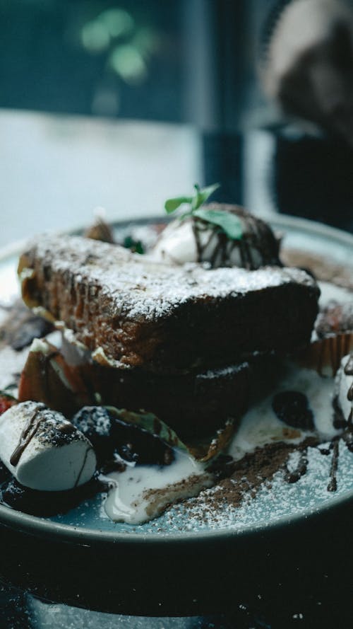 Delicious Chocolate Cake with White Cream on Ceramic Plate