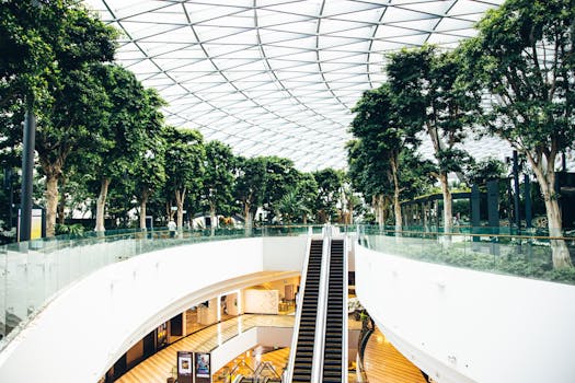 Modern architecture at Jewel Changi Airport with greenery and escalators.