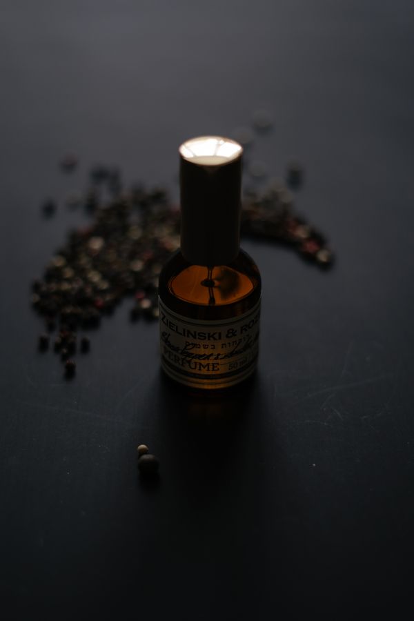 Amber bottle on a dark backdrop — photo by Albina White on Pexels