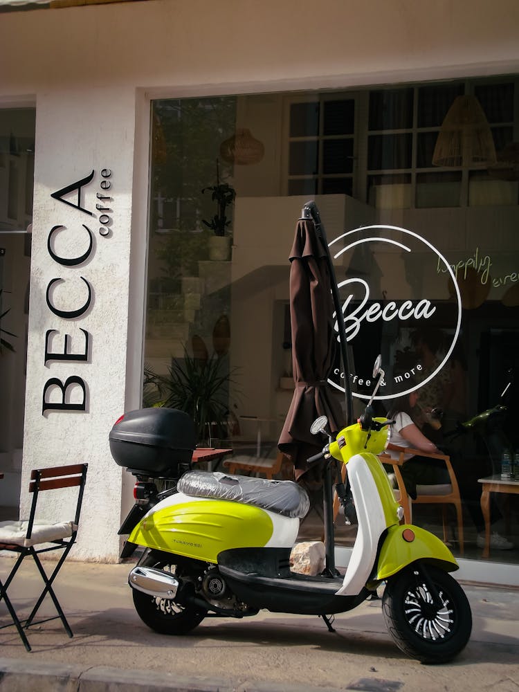 Scooter Parked In Front Of A Restaurant 