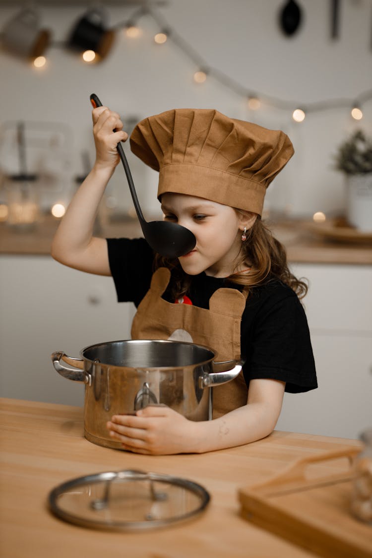 A Kid Tasting The Soup