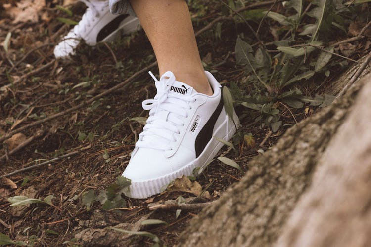 Close-up Of Humans Feet With Puma Trainers Shoes