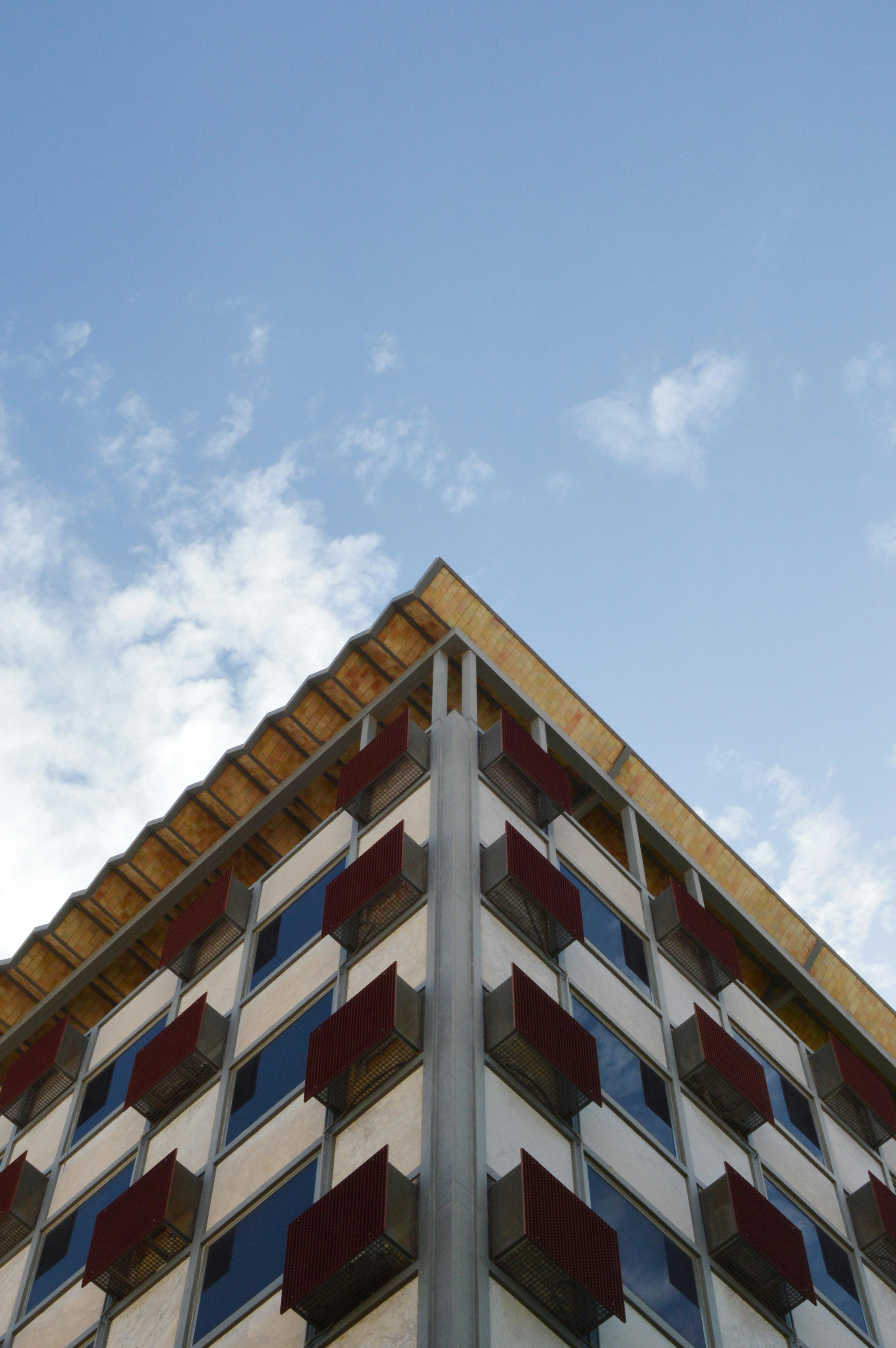 Free A striking perspective view of a modern building in Alicante, Spain against a blue sky. Stock Photo