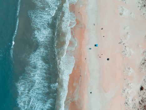 Drone shot capturing the serene shoreline and waves of St. Augustine Beach, Florida.