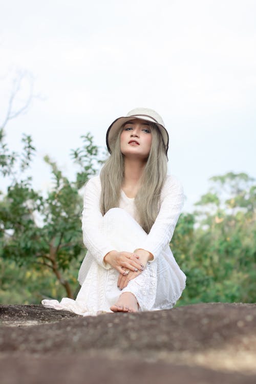 Woman in White Long Sleeve Dress and White Hat