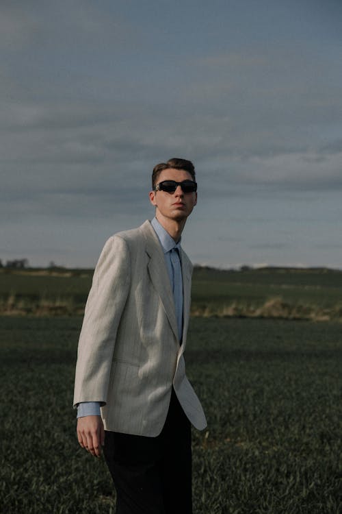 Close Up Photo of Man Wearing Suit Jacket