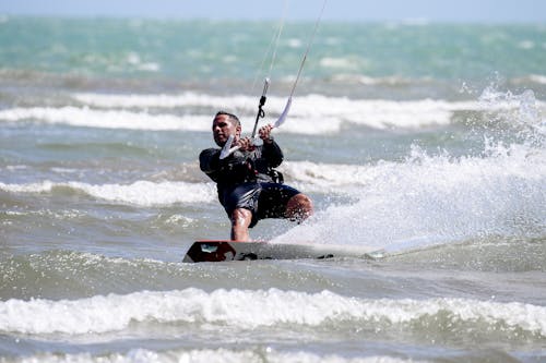 A Man in Kitesurfing on the Beach