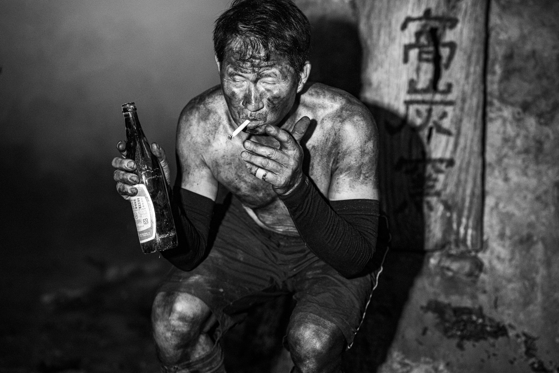 Asian Coal Miner Having Break from Work