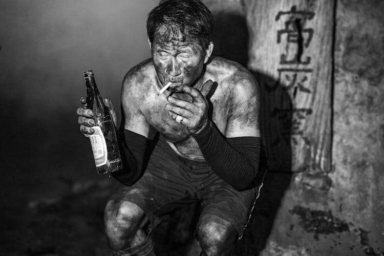 Asian Coal Miner Having Break From Work