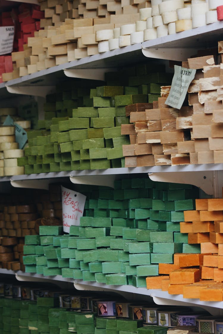 Items In Different Colours Piled On Shelves In A Shop 