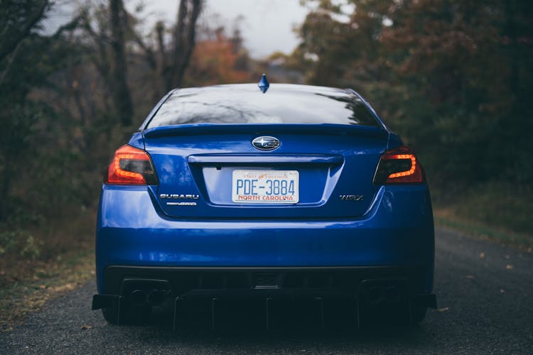 Blue Subaru Car Driving On Forest Road