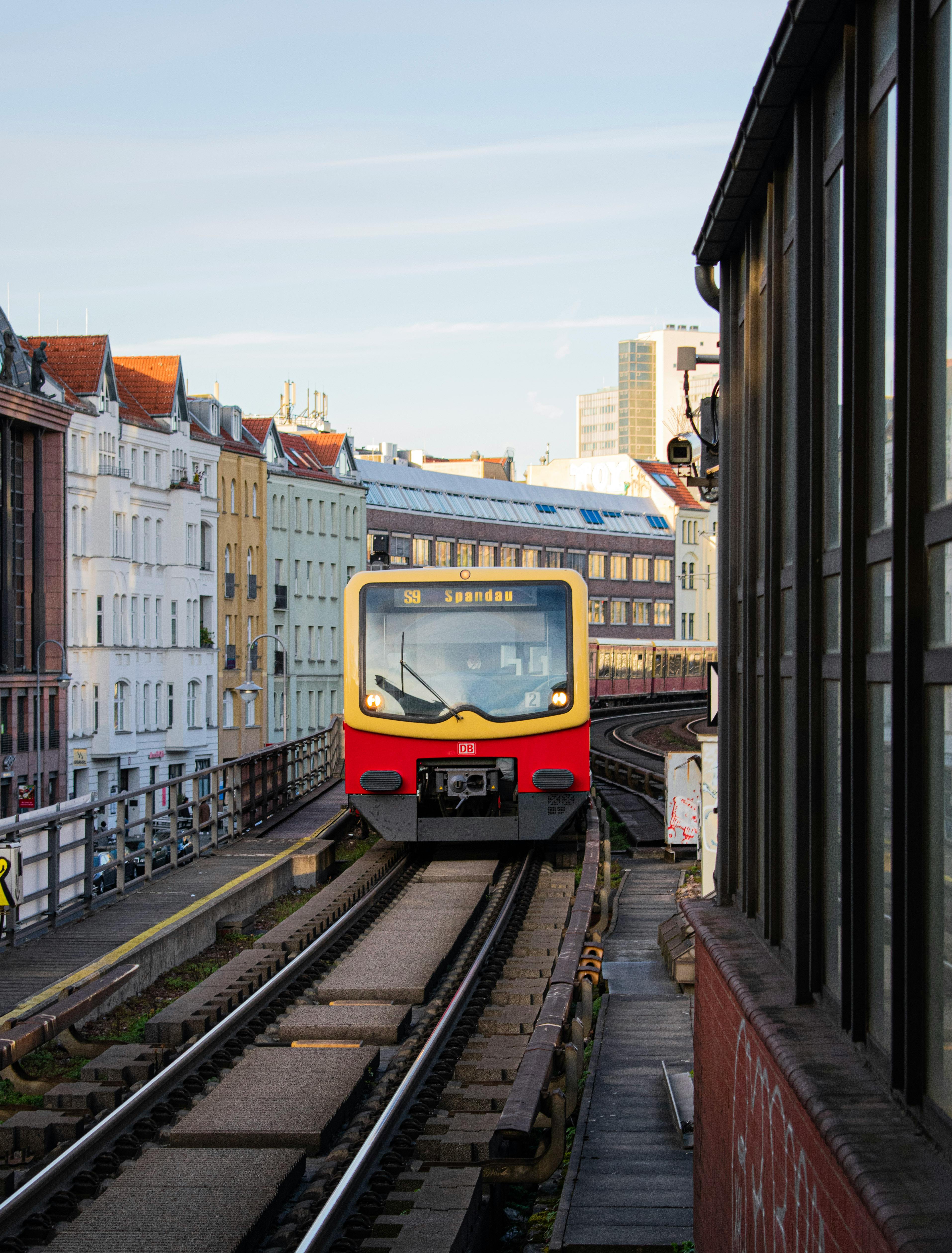 Free S-Bahn train on elevated tracks in urban Berlin setting, showcasing city architecture. Stock Photo
