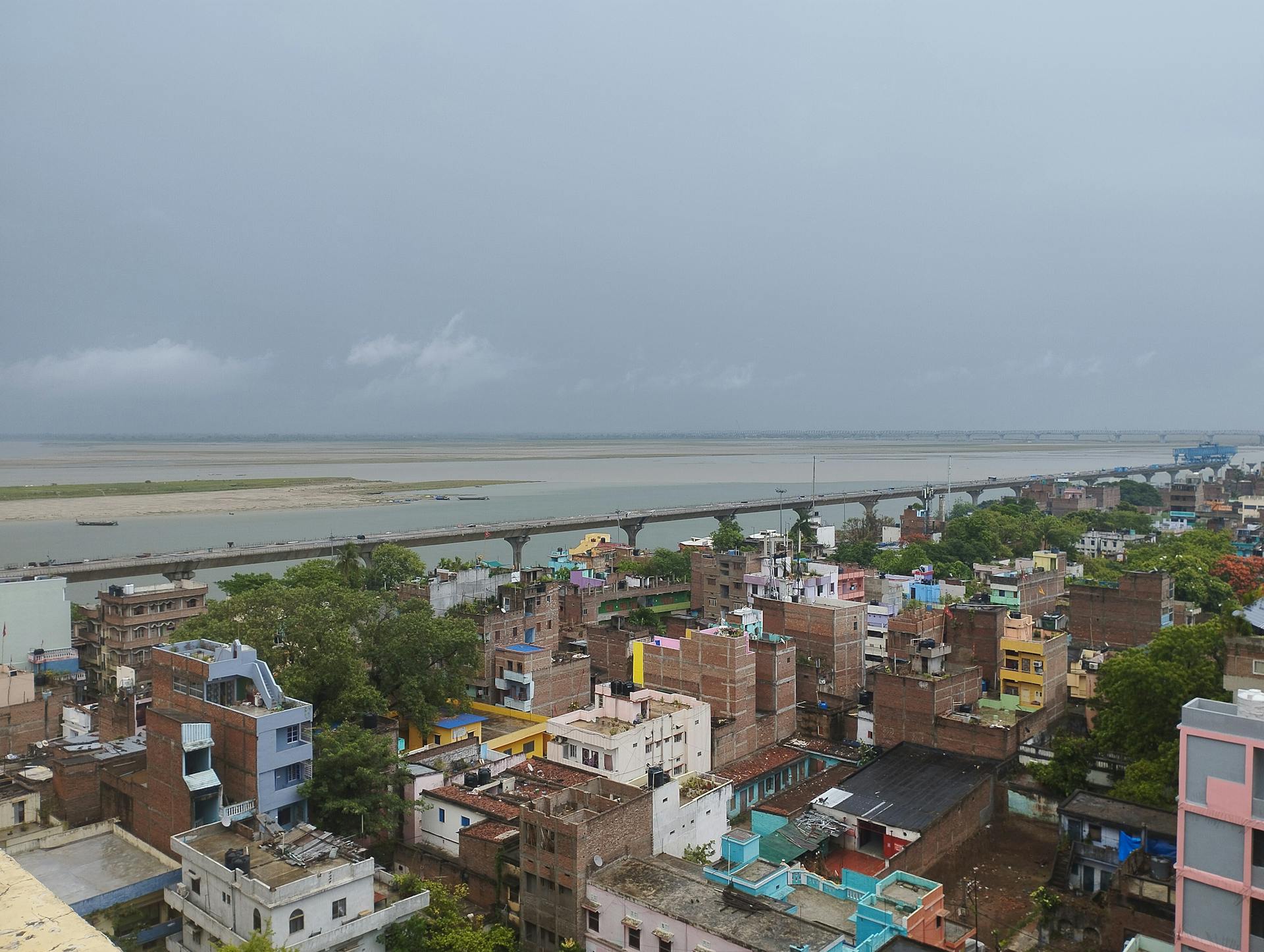 A vibrant aerial view of Gandhi Setu Bridge spanning the Ganges River in Patna, India.