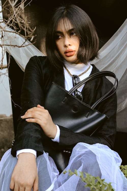 Woman with a Black Leather Bag Posing