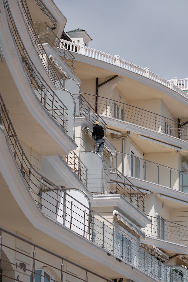 A Man Cleaning The Glass Windows