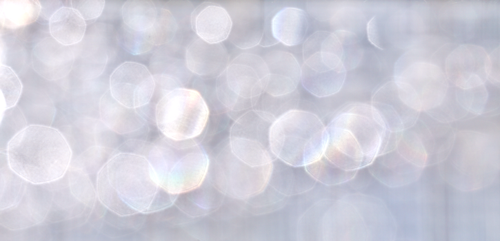 Soft abstract bokeh background with shimmering light effects.