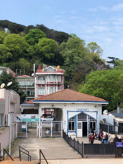 Free Colorful building in Sariyer with lush greenery, vibrant architecture and people walking. Stock Photo
