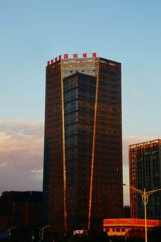 Sunset view of a modern high-rise building in downtown Tokyo, Japan.