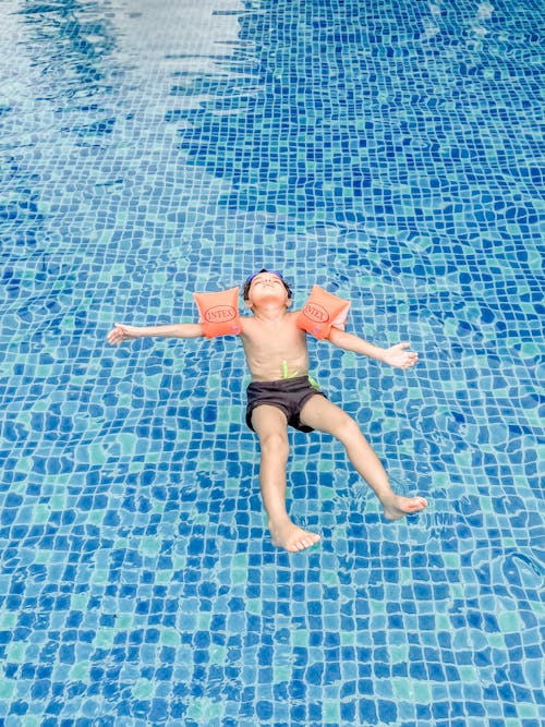 A Boy Swimming in the Swimming Pool