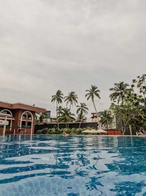 Brown Wooden House Near Swimming Pool