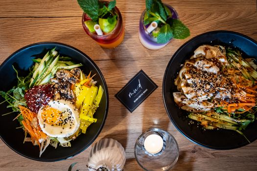 Top-down view of delicious Asian fusion bowls with vibrant smoothies, perfect for food photography enthusiasts.