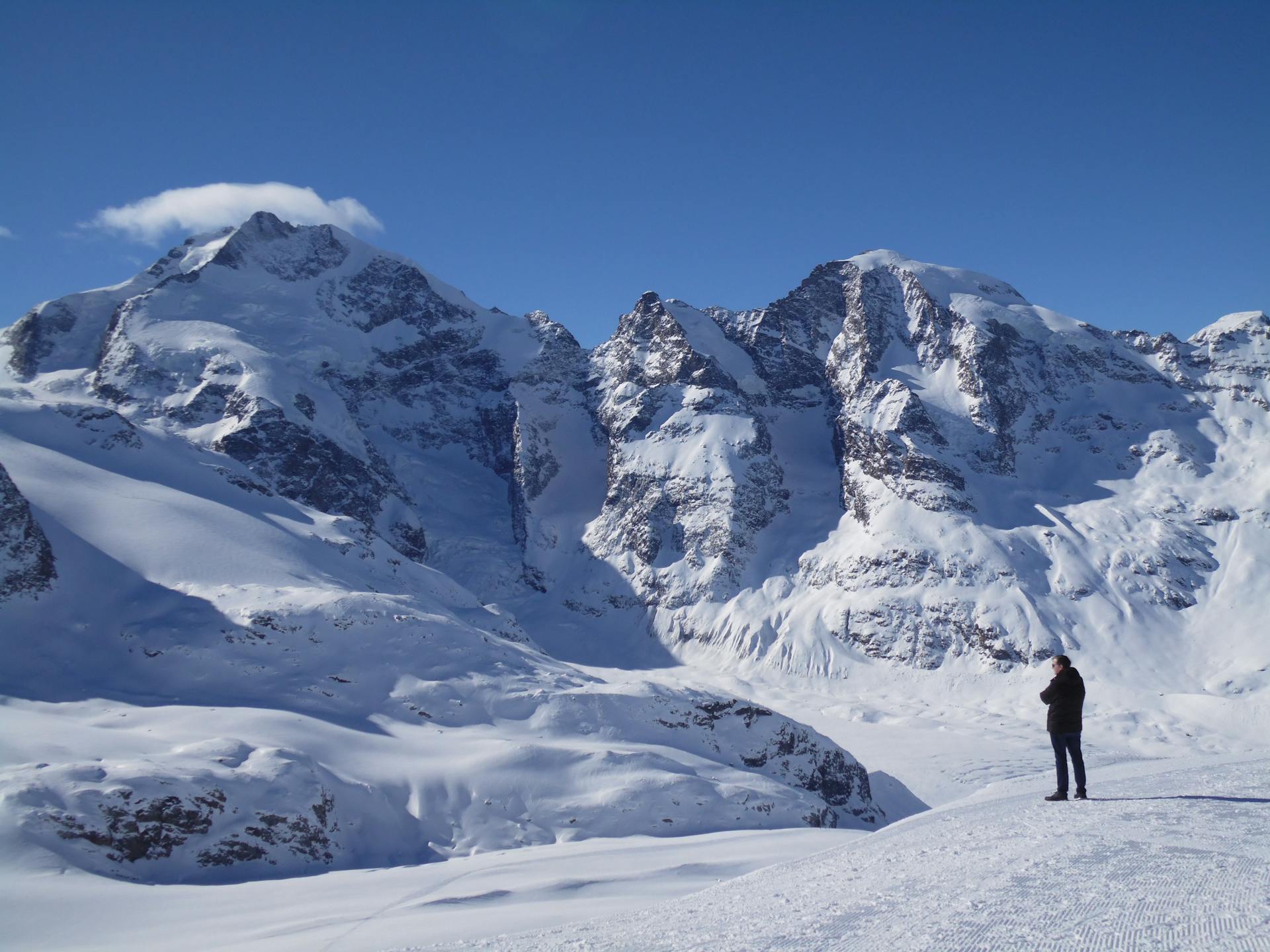 Small human adoring huge mountains of Switzerland.