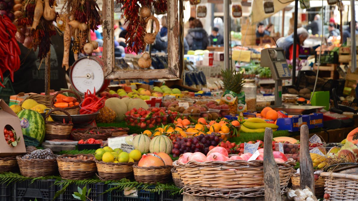 Fresh fruits and vegetables displayed at market stalls