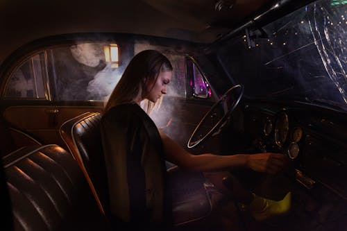 A Woman Starting the Engine of Her Car
