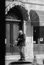Man in Black Jacket Standing Beside Door