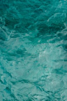 Serene view of turquoise water with gentle waves, highlighting purity and tranquility.