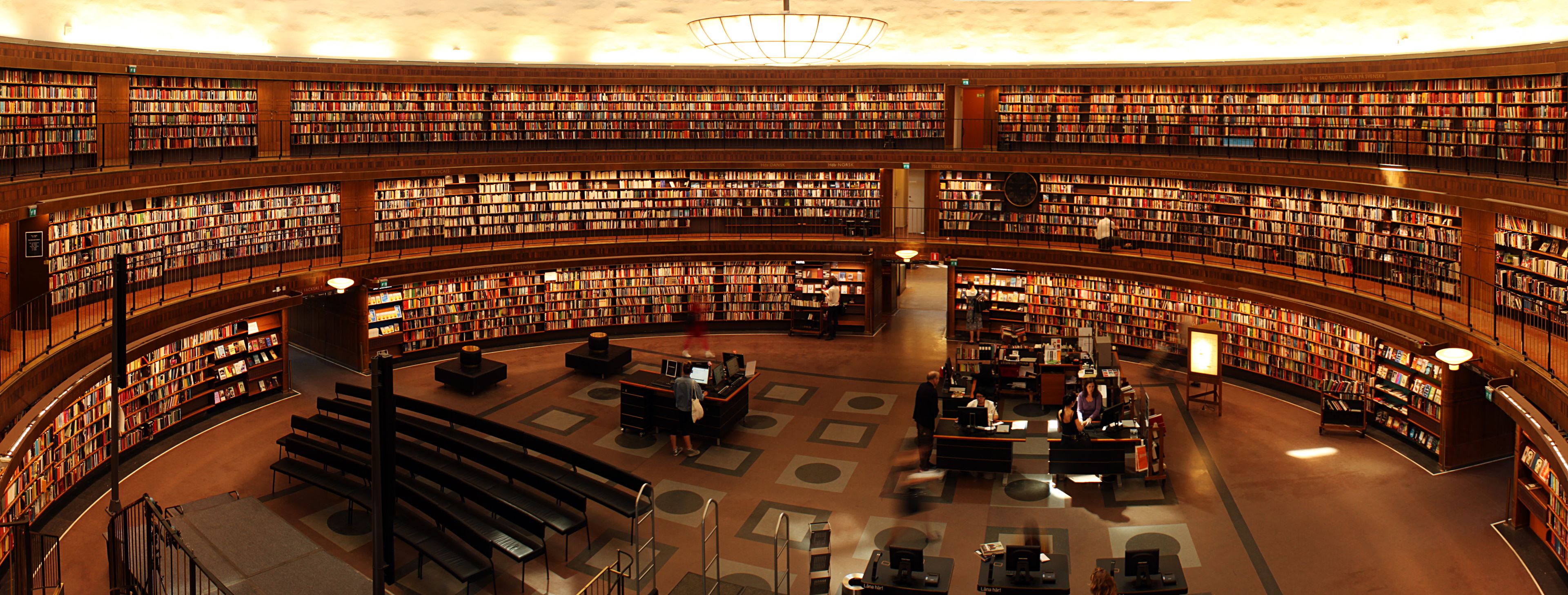 Curved library shelves lined with books